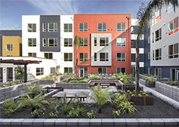 Interior courtyard of one of the buildings at Alice Griffith, showing seating areas and planter boxes.